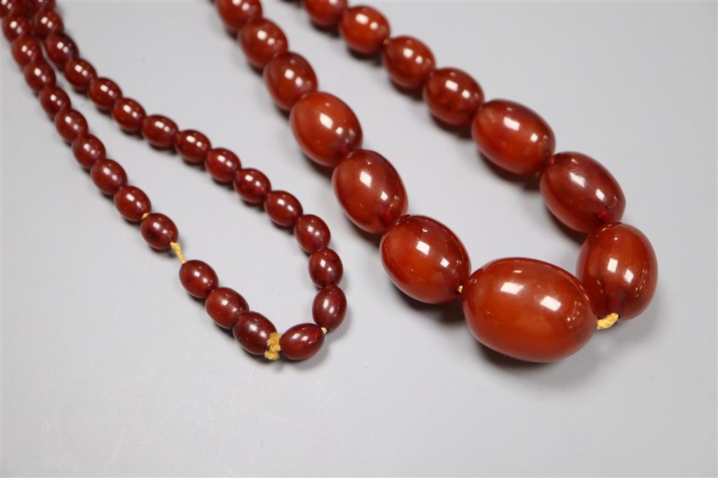 A single strand graduated oval simulated amber bead necklace, 80cm, gross 70 grams.